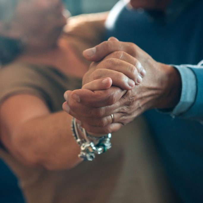 senior couple dancing hand in hand - elderly taking tango course